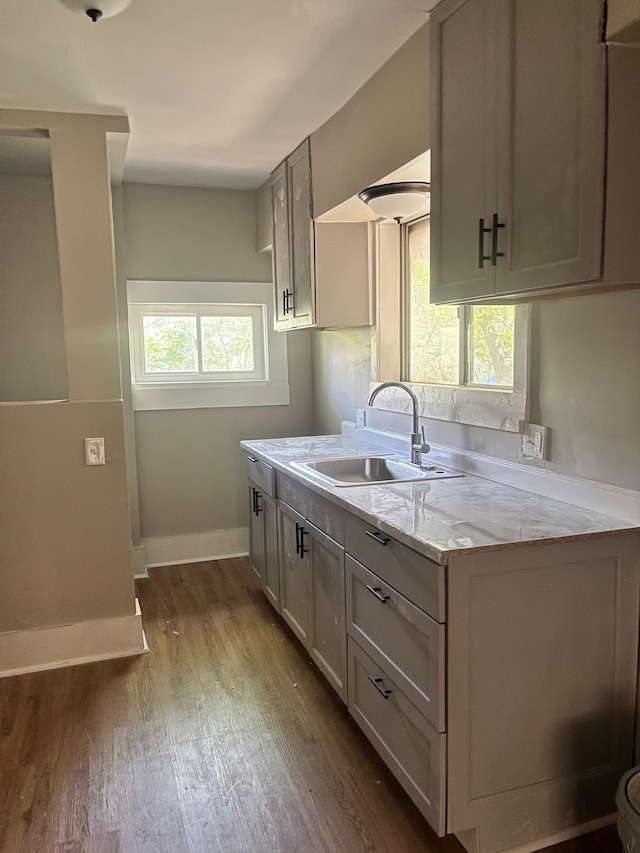 27305 Norfolk St, Inkster, MI 48141 - kitchen with a sink, dark wood-type flooring, baseboards, and light stone countertops