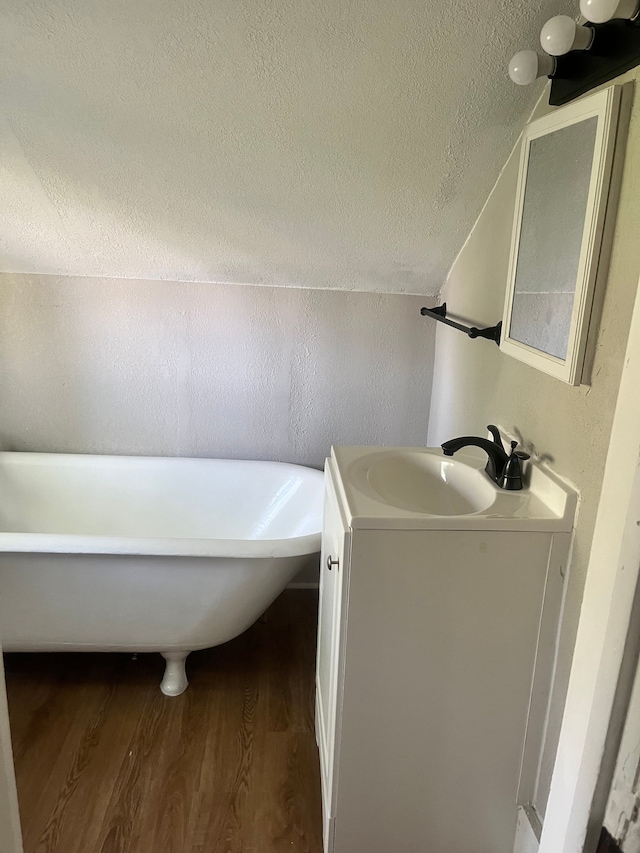27305 Norfolk St, Inkster, MI 48141 - bathroom with wood finished floors, a textured ceiling, a freestanding bath, and vanity