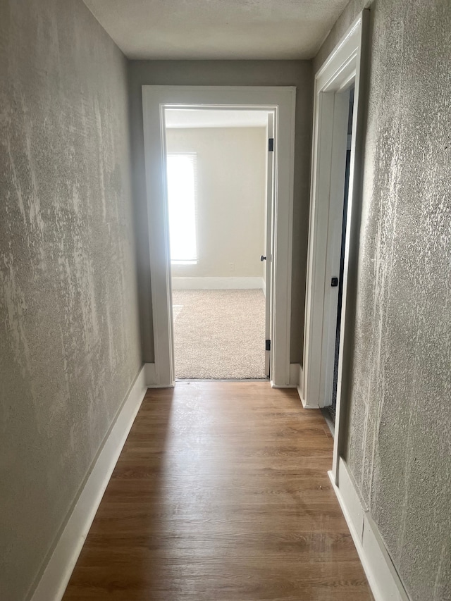 27305 Norfolk St, Inkster, MI 48141 - corridor featuring wood finished floors, a textured wall, and baseboards