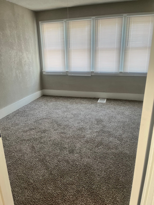 27305 Norfolk St, Inkster, MI 48141 - empty room featuring carpet floors, a textured wall, and baseboards