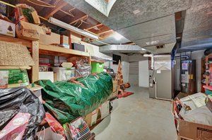storage room with water heater and heating unit