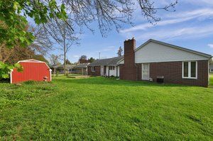 view of grassy yard with a shed