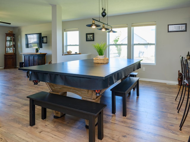 dining space featuring wood finished floors and baseboards