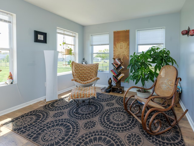 sitting room with wood finished floors and baseboards