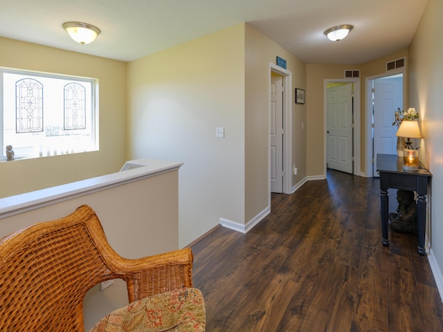 hallway with dark wood-style floors and baseboards