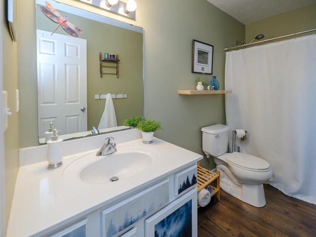 bathroom featuring toilet, wood finished floors, vanity, and a shower with curtain