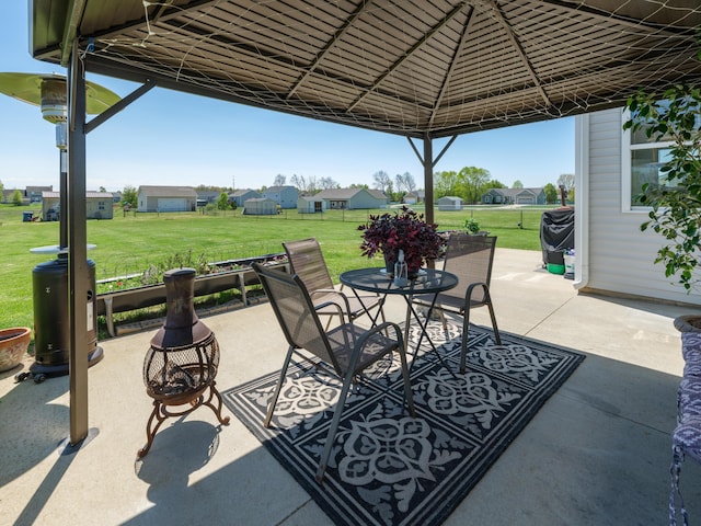 view of patio / terrace featuring outdoor dining space, a gazebo, and a residential view