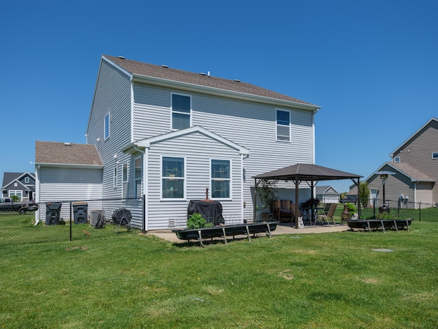 back of property with a gazebo and a patio