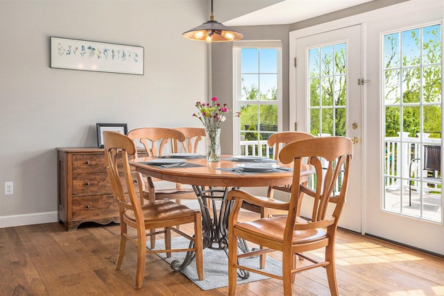 dining room with light wood-style flooring and baseboards