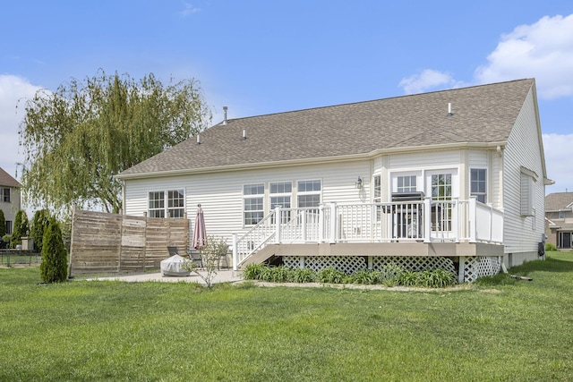 back of house with a deck and a shingled roof