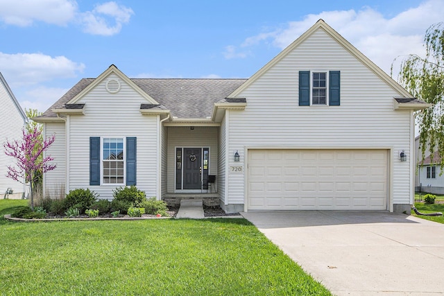 traditional home featuring a front lawn, concrete driveway, an attached garage, and a shingled roof