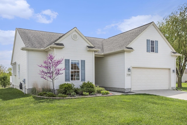 traditional-style house featuring concrete driveway, roof with shingles, an attached garage, and a front yard