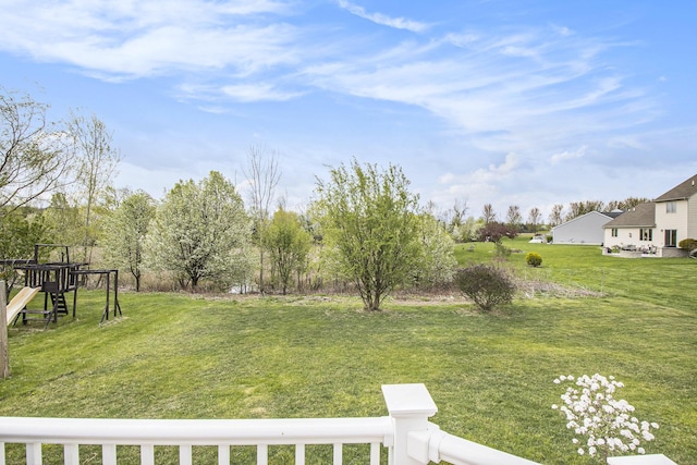view of green lawn with a playground