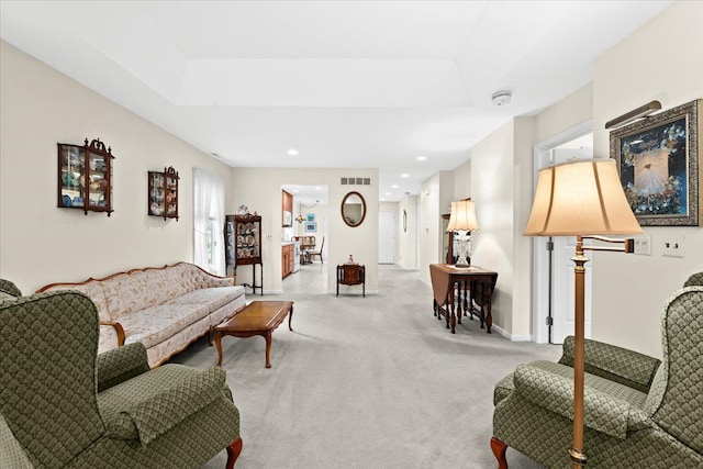 living area featuring light colored carpet, recessed lighting, and baseboards