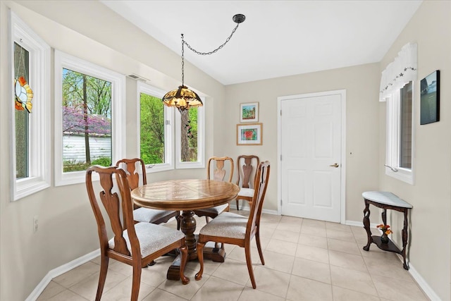 dining space with baseboards and light tile patterned floors