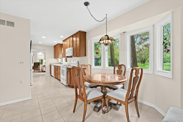 dining space featuring baseboards, a chandelier, light tile patterned floors, and recessed lighting