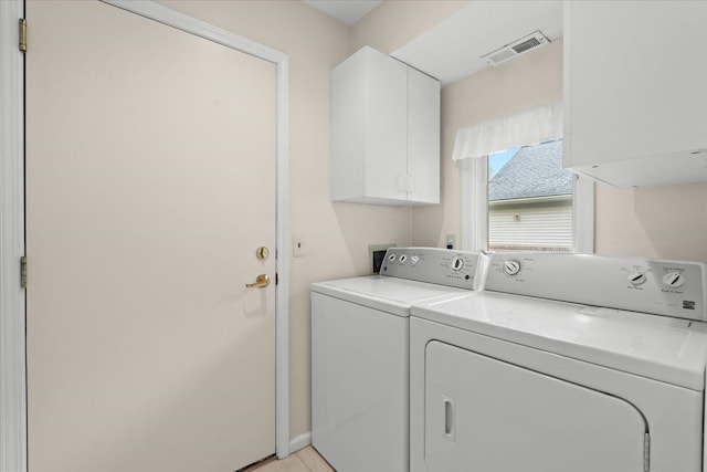 laundry room with cabinet space, separate washer and dryer, and baseboards