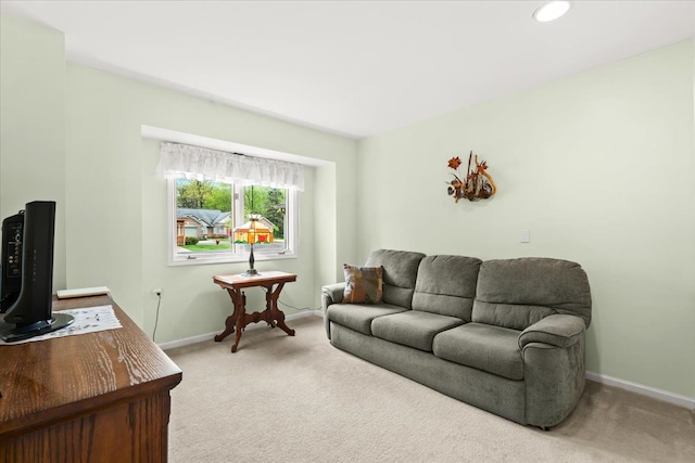 carpeted living room featuring baseboards