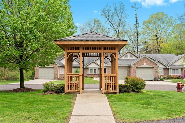 view of front of house with brick siding, a front lawn, an attached garage, and concrete driveway