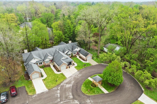 view from above of property featuring a heavily wooded area