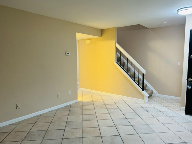interior space featuring tile patterned flooring and baseboards