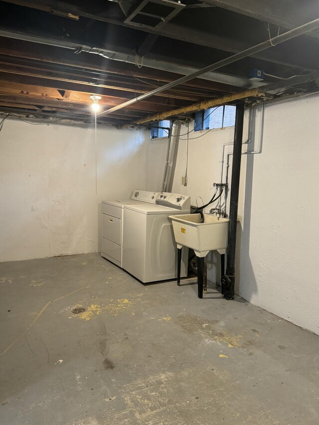 below grade area featuring washing machine and clothes dryer