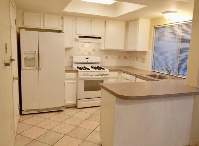 kitchen with white appliances, a sink, extractor fan, and tasteful backsplash
