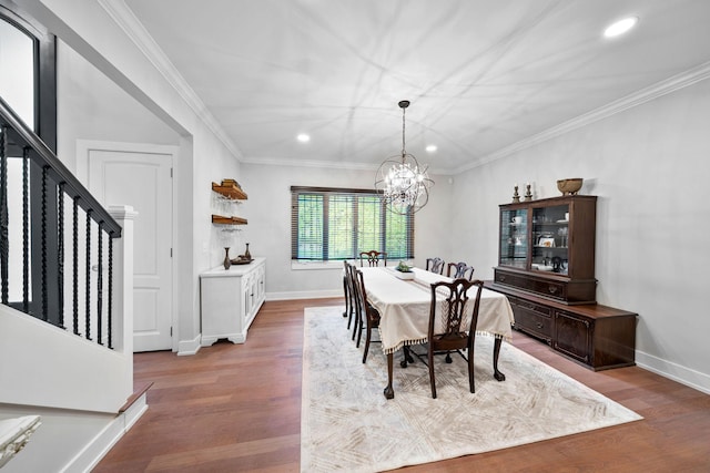 dining area featuring recessed lighting, a chandelier, wood finished floors, stairs, and crown molding