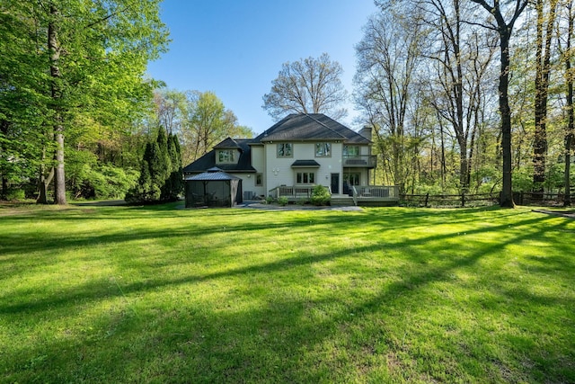 view of front of house featuring a gazebo, a balcony, and a deck
