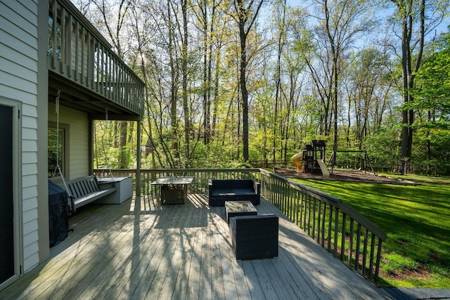 wooden deck featuring a yard, an outdoor hangout area, and a playground