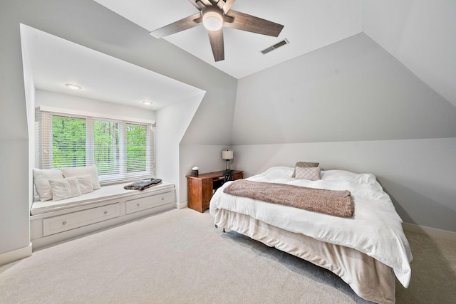carpeted bedroom featuring vaulted ceiling and a ceiling fan