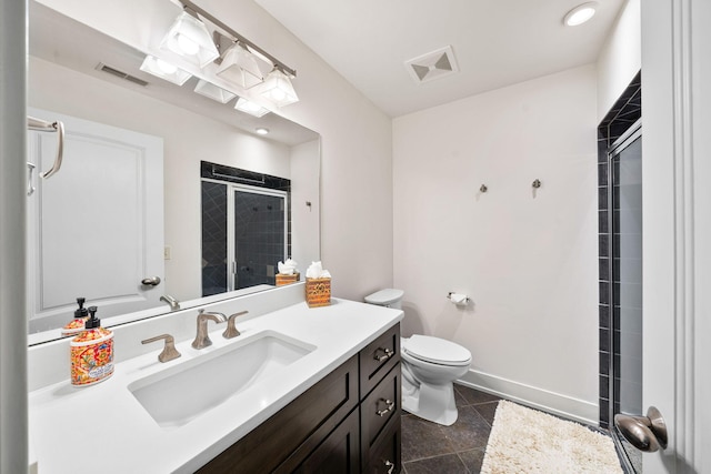 full bath with a stall shower, toilet, vanity, baseboards, and tile patterned flooring