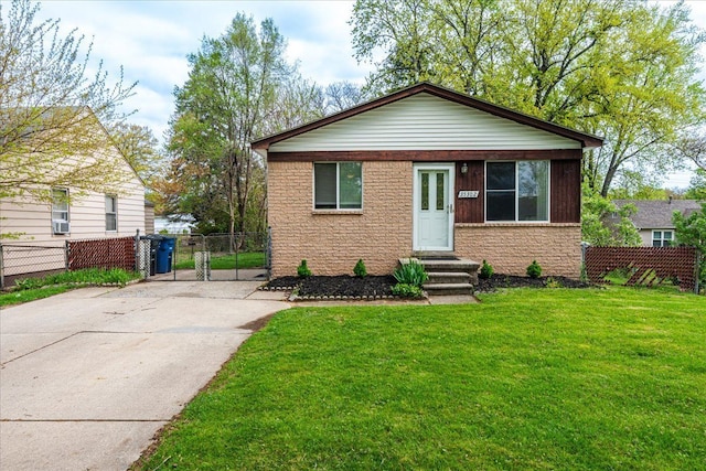 bungalow-style home featuring a gate, concrete driveway, brick siding, and entry steps