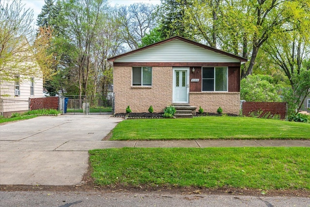 bungalow with entry steps, driveway, and brick siding