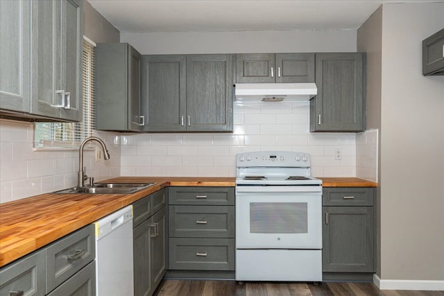 kitchen with wooden counters, a sink, white appliances, gray cabinetry, and under cabinet range hood
