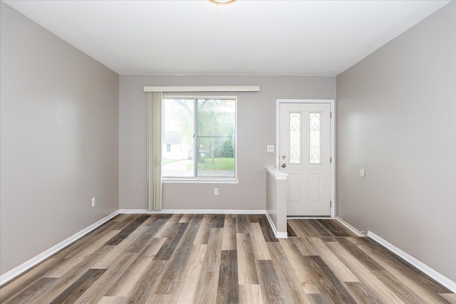 entryway with wood finished floors and baseboards