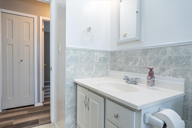 bathroom with vanity, tile walls, and a wainscoted wall