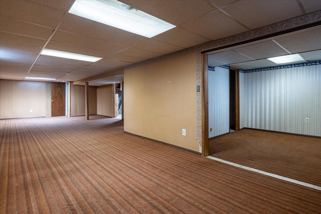 empty room with carpet floors and a paneled ceiling