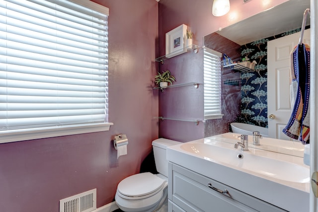 bathroom featuring toilet and vanity