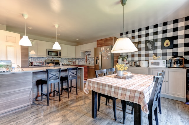 dining space with light wood-style floors