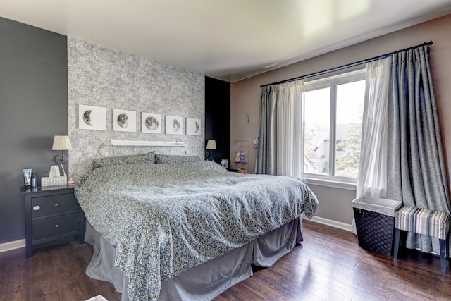 bedroom with dark wood-style flooring and baseboards
