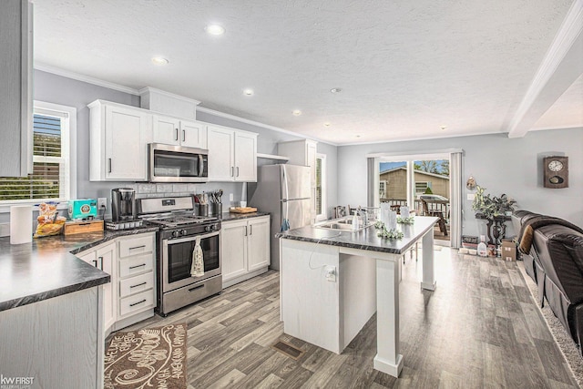 39500 Warren Rd, Canton, MI 48187 - kitchen with stainless steel appliances, dark countertops, light wood-type flooring, recessed lighting, and a textured ceiling