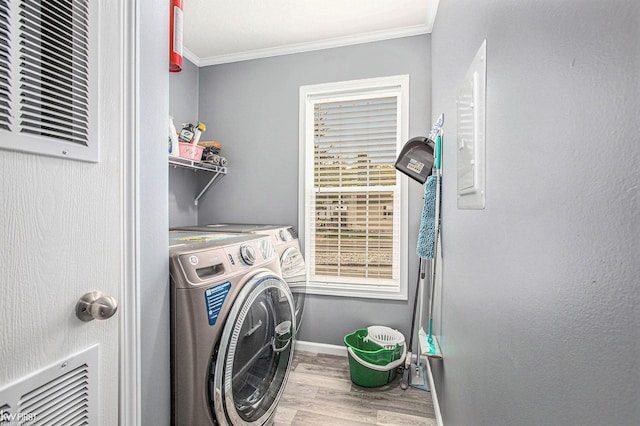 39500 Warren Rd, Canton, MI 48187 - washroom featuring wood finished floors, crown molding, and washing machine and clothes dryer