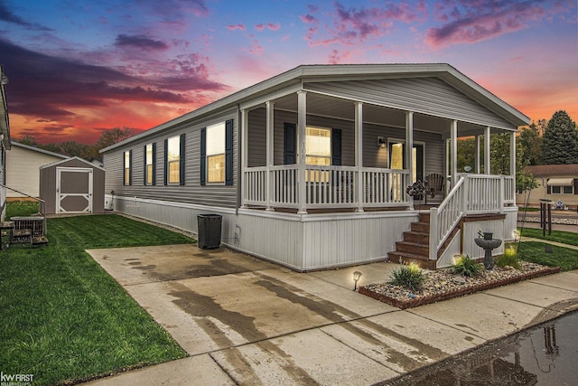 39500 Warren Rd, Canton, MI 48187 - manufactured / mobile home featuring a storage shed, a porch, and a lawn