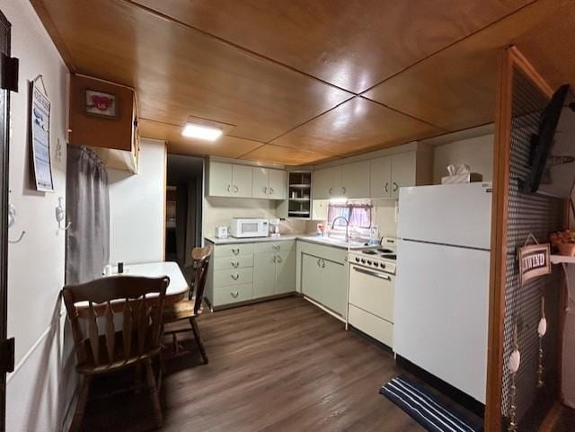 kitchen featuring white appliances, dark wood-style floors, open shelves, a sink, and light countertops