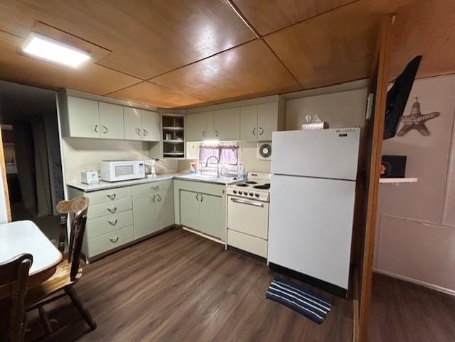 kitchen with white appliances, a sink, dark wood-type flooring, and light countertops