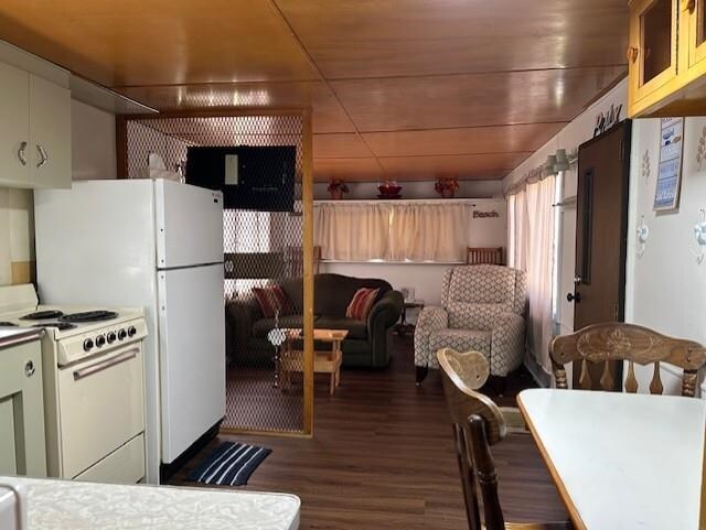 kitchen with white gas range oven and wood finished floors