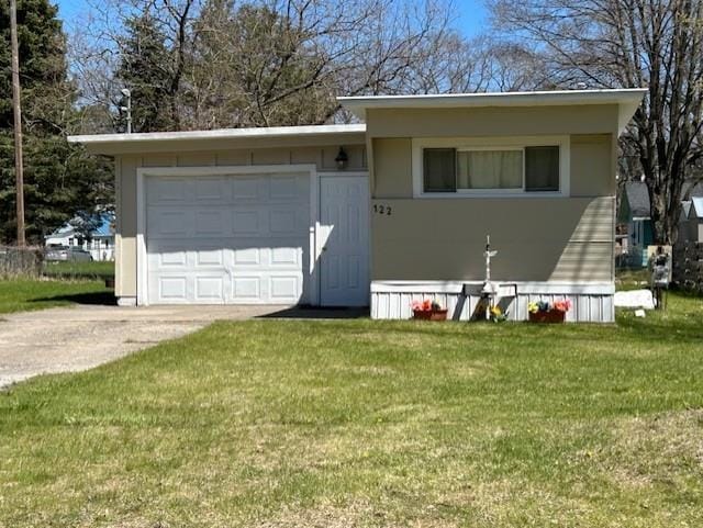 view of front facade featuring concrete driveway, a front yard, and an attached garage
