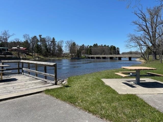 dock with a water view and a lawn