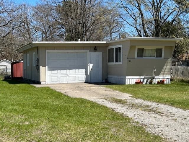 view of front facade with concrete driveway, an attached garage, a front yard, and board and batten siding